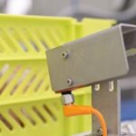 Yellow box identification sensor installed at the end-of-line automatic sorting system of a meat processing plant